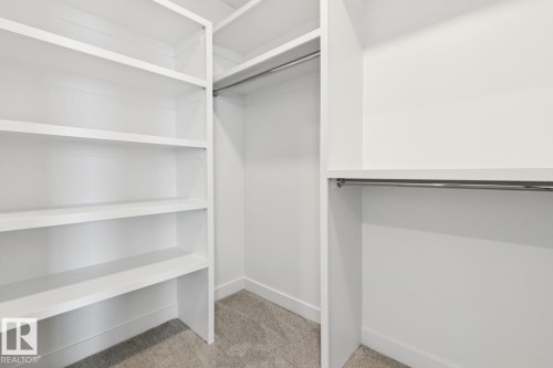 Built-in shelving, two hanging rods, and an overhead shelf provide ample storage - 72 Maple Crescent, Gibbons, AB 