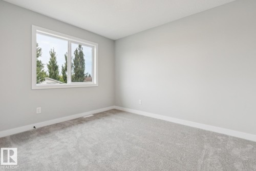 Neutral gray wall finishes, white trim, and light gray carpeting - 72 Maple Crescent, Gibbons, AB 