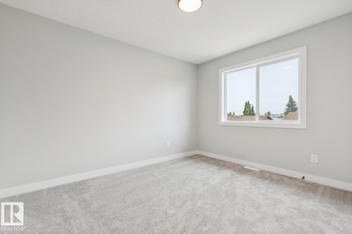 Carpeted flooring, white trim, light gray painted walls, a single window, and a ceiling-mounted light fixture - 72 Maple Crescent, Gibbons, AB 
