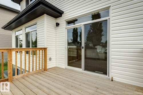 Wood-finish deck with a natural wood railing - 72 Maple Crescent, Gibbons, AB 