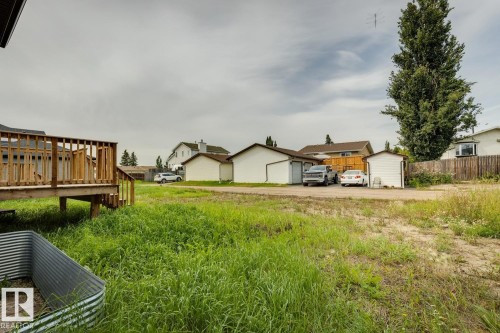 Raised wood deck with railings and steps - 72 Maple Crescent, Gibbons, AB 