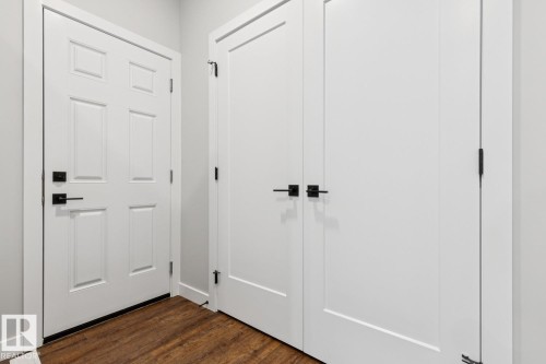White paneled doors with matte black hardware - 72 Maple Crescent, Gibbons, AB 