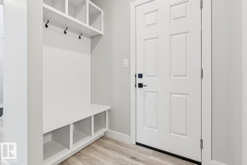 Built-in storage bench with cubbies, upper shelving, and coat hooks - 36 Maple Crescent, Gibbons, AB 