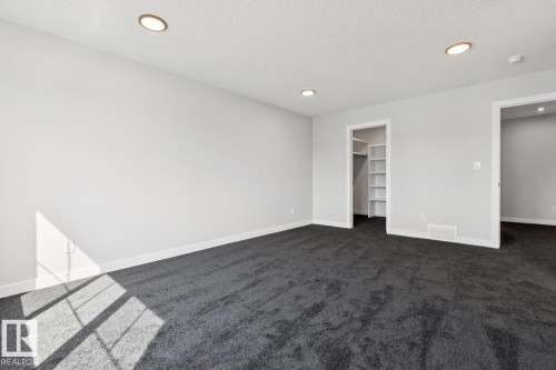 Recessed lighting, wall-to-wall carpeting, built-in closet shelving, and a neutral color palette - 36 Maple Crescent, Gibbons, AB 