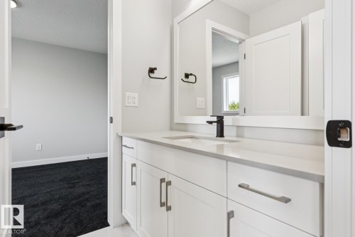 White shaker-style vanity with a light-toned countertop and an integrated sink - 36 Maple Crescent, Gibbons, AB 