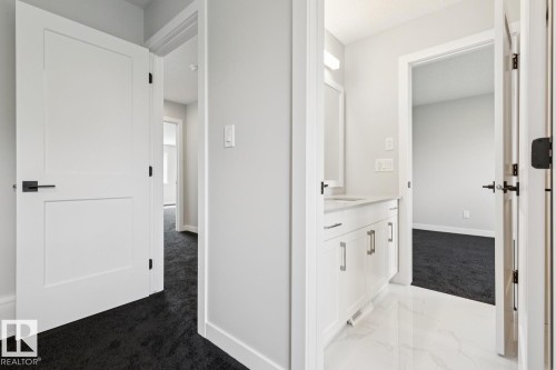 White vanity with a light countertop and polished hardware - 36 Maple Crescent, Gibbons, AB 