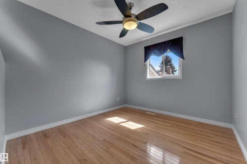 Hardwood flooring, painted walls, ceiling fan with integrated lighting, and a window - 9722 157 Street Nw, Edmonton, AB 