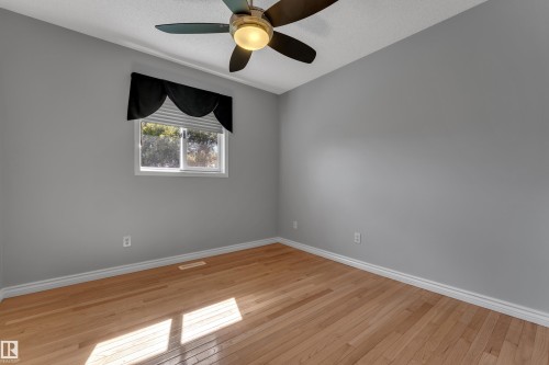 Hardwood flooring, painted walls, single window, ceiling fan, and white trim - 9722 157 Street Nw, Edmonton, AB 