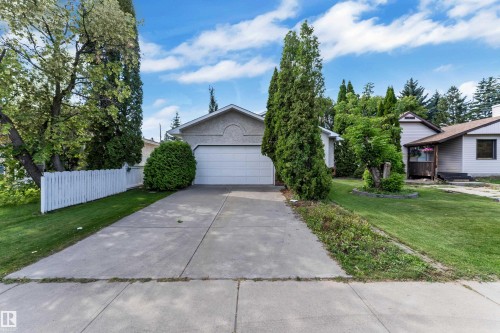 Concrete driveway leading to an attached garage - 9722 157 Street Nw, Edmonton, AB 