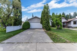 Concrete driveway leading to an attached garage - 