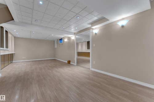 Expansive room with wood-finish flooring, recessed lighting, and neutral wall tones - 9722 157 Street Nw, Edmonton, AB 
