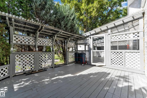 Expansive outdoor deck with a covered pergola, lattice privacy screens, and a built-in outdoor bar - 9722 157 Street Nw, Edmonton, AB 