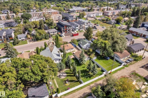 Gable roof property with a light-colored exterior, surrounded by mature trees - 9722 157 Street Nw, Edmonton, AB 