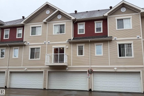 Multi-level facade with beige horizontal siding and contrasting red upper-level siding - #31 460 Hemingway Rd Nw, Edmonton, AB 