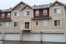 Multi-level facade with beige horizontal siding and contrasting red upper-level siding - #31 460 Hemingway Rd Nw, Edmonton, AB 