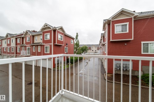 Multi-level townhome architecture with red siding and light trim - #31 460 Hemingway Rd Nw, Edmonton, AB 