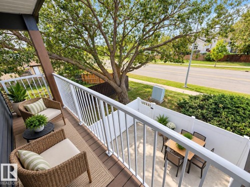 Private balcony with wood-finish decking and white railings - 3526 42 Street Nw, Edmonton, AB 