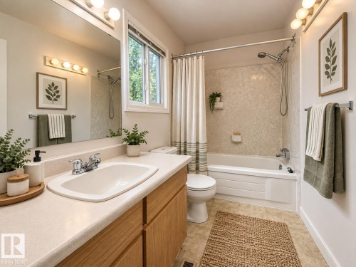 Bathroom with a single vanity, integrated sink, light wood-finish cabinetry, and a shower-over-tub combination - 3526 42 Street Nw, Edmonton, AB 