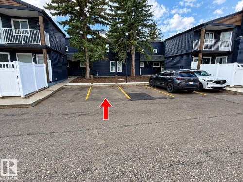Asphalt surface parking with painted yellow lines - 3526 42 Street Nw, Edmonton, AB 