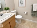 Vanity with a laminate countertop, integrated sink, and wood-finish cabinetry - 3526 42 Street Nw, Edmonton, AB 
