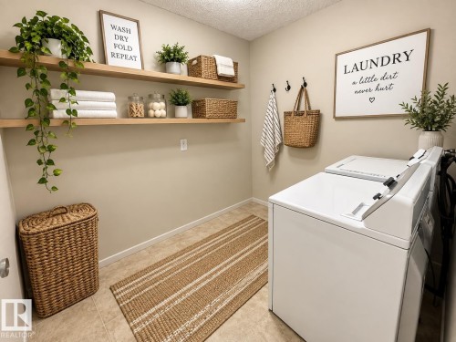 Dedicated laundry space featuring a tile floor, two floating wood-finish shelves, and wall-mounted hooks - 3526 42 Street Nw, Edmonton, AB 