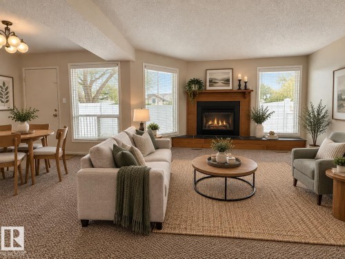 Living area featuring a gas fireplace with a wood surround and mantel - 3526 42 Street Nw, Edmonton, AB 