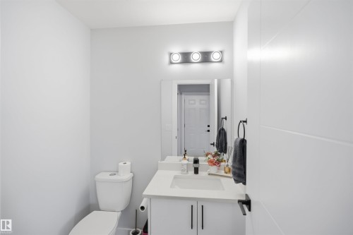 Modern vanity with integrated sink, white countertop, and dark hardware - 2122 37 Avenue Nw, Edmonton, AB 