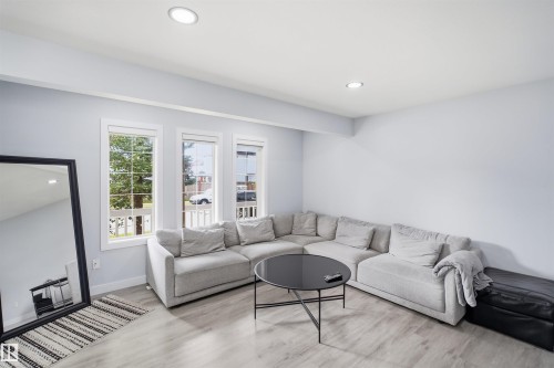Recessed ceiling lighting, multiple windows with white trim, and wood-finish flooring - 2122 37 Avenue Nw, Edmonton, AB 