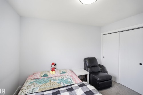 Neutral wall color, ceiling-mounted light fixture, and sliding closet doors - 2122 37 Avenue Nw, Edmonton, AB 