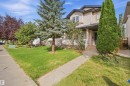 Two-story siding exterior with a covered front porch and a paved walkway - 2122 37 Avenue Nw, Edmonton, AB 