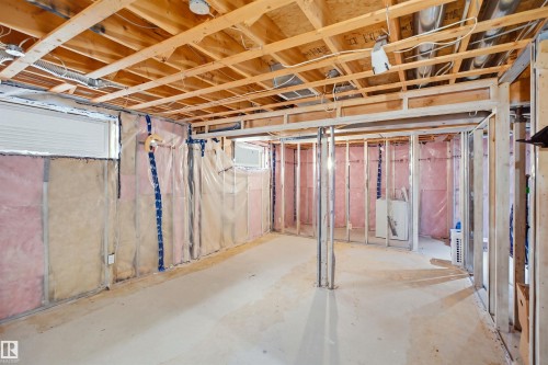 Unfinished basement with exposed wood joists, concrete flooring, insulated perimeter walls, and framed interior partitions - 2122 37 Avenue Nw, Edmonton, AB 