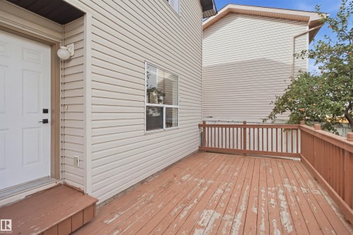 Expansive outdoor deck with wood railing, offering a dedicated exterior space - 2122 37 Avenue Nw, Edmonton, AB 