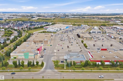 Retail center with multiple commercial buildings and extensive surface parking - 2122 37 Avenue Nw, Edmonton, AB 