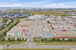 Retail center with multiple commercial buildings and extensive surface parking - 