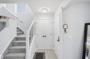 Light wood-finish flooring, white walls, and a contemporary flush mount ceiling light - 2122 37 Avenue Nw, Edmonton, AB 