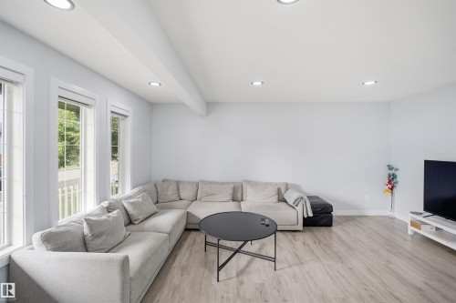 Recessed ceiling lighting, wood-finish flooring, multiple windows, and crisp white walls - 2122 37 Avenue Nw, Edmonton, AB 