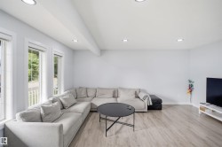 Recessed ceiling lighting, wood-finish flooring, multiple windows, and crisp white walls - 