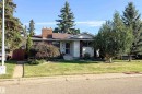 Single-story residence featuring a brick chimney, established landscaping, and mature trees - 10438 32A Avenue Nw, Edmonton, AB 