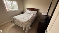 Carpeted flooring, neutral wall tones, and a window with blinds - 