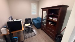 Wood-finish flooring with neutral wall tones and a window featuring horizontal blinds - 