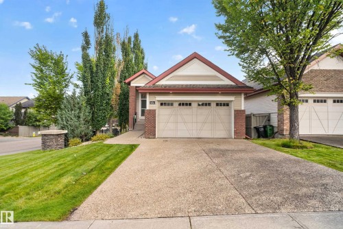 Brick and siding exterior with a peaked roofline, attached two-car garage, and an exposed aggregate driveway - 904 Armitage Court Sw, Edmonton, AB 