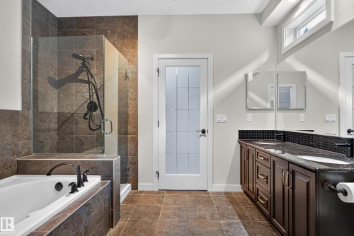 Walk-in shower with clear glass enclosure and tile surround - 904 Armitage Court Sw, Edmonton, AB 