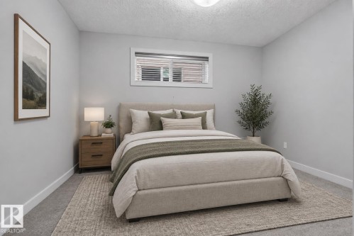 Recessed window with horizontal blinds, wall-to-wall carpeting, and a built-in ceiling light fixture - 904 Armitage Court Sw, Edmonton, AB 
