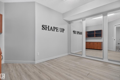 Wood-finish flooring with a neutral wall color - 904 Armitage Court Sw, Edmonton, AB 