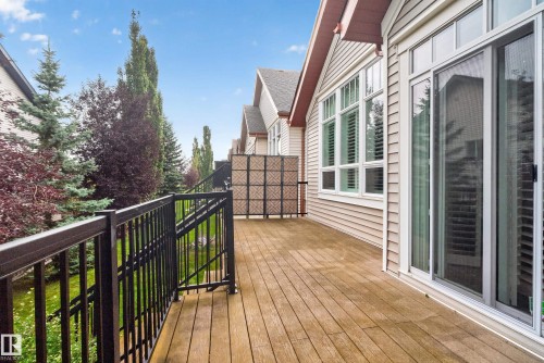 Expansive wood deck with black metal railings - 904 Armitage Court Sw, Edmonton, AB 