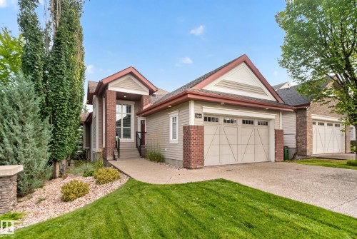 Exterior featuring brick accents, horizontal siding, a gabled roofline, and an attached garage with a paved driveway - 904 Armitage Court Sw, Edmonton, AB 