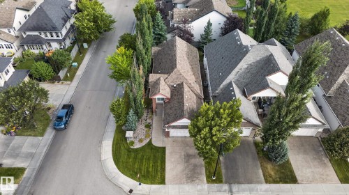 Pitched roofline residential property with attached garage, concrete driveway, and front landscaping - 904 Armitage Court Sw, Edmonton, AB 