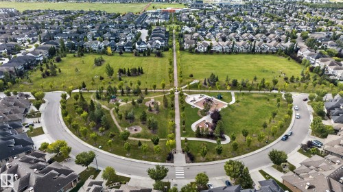 Residential neighborhood featuring extensive green spaces, mature trees, paved walking paths, and multiple playground areas - 904 Armitage Court Sw, Edmonton, AB 