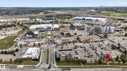 Mixed-use commercial development featuring multiple retail buildings, a multi-story residential building, and extensive surface parking - 904 Armitage Court Sw, Edmonton, AB 