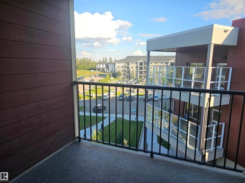 Private balcony with textured flooring and black metal railings - #421 5816 Mullen Place Nw, Edmonton, AB 